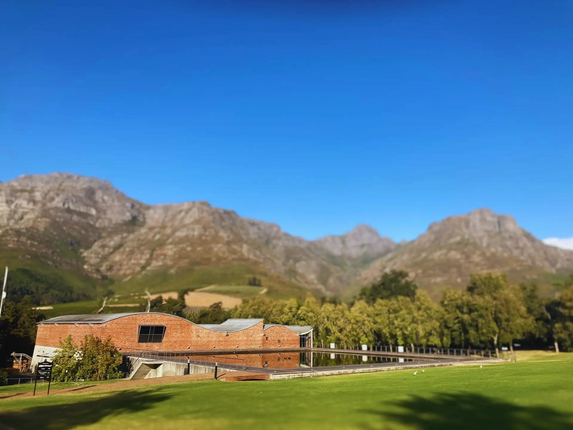Winelands estate and reflecting pool below the mountains