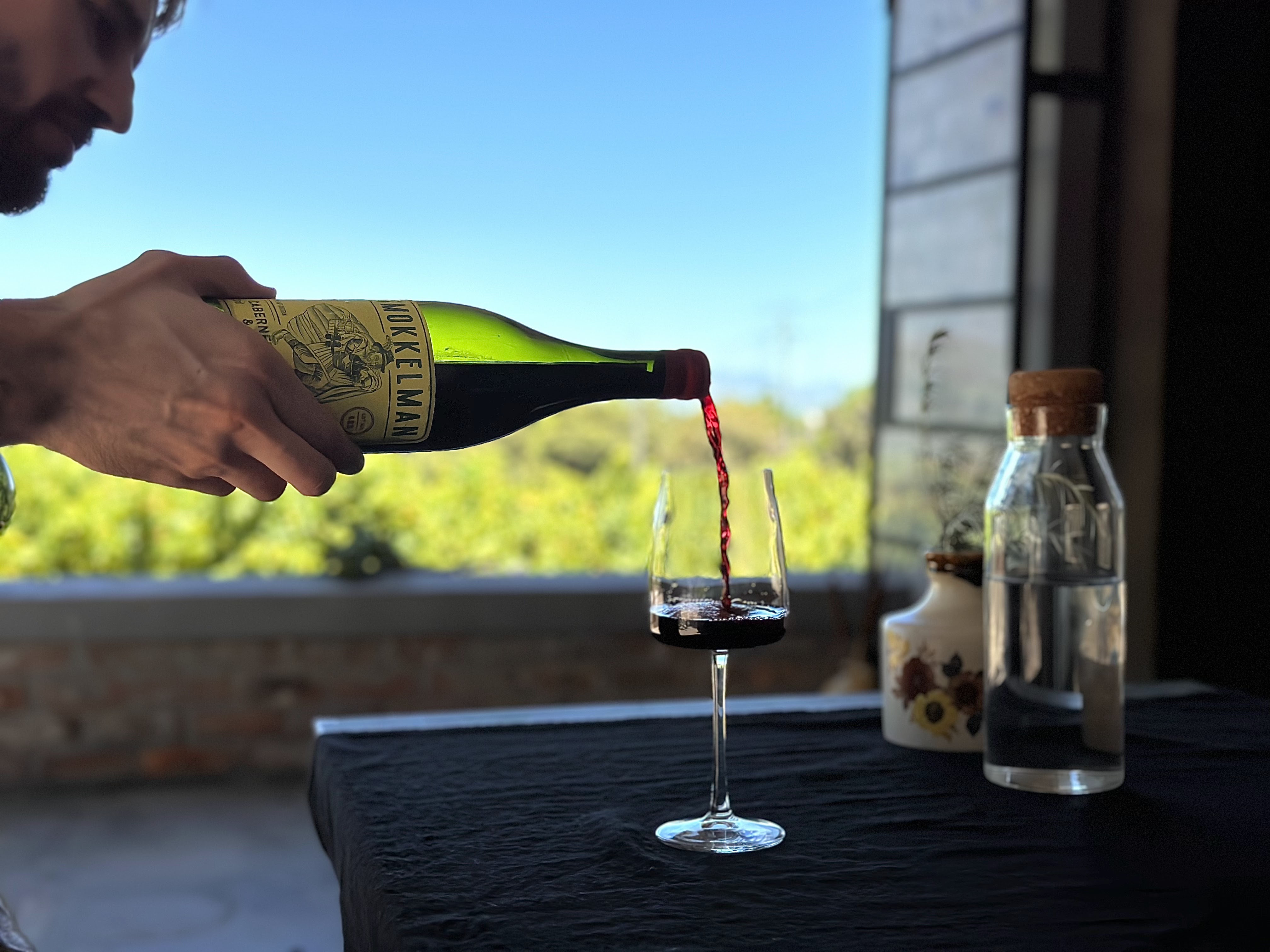 Pouring a Mokelman red wine at Karibi Wine Cave, Stellenbosch