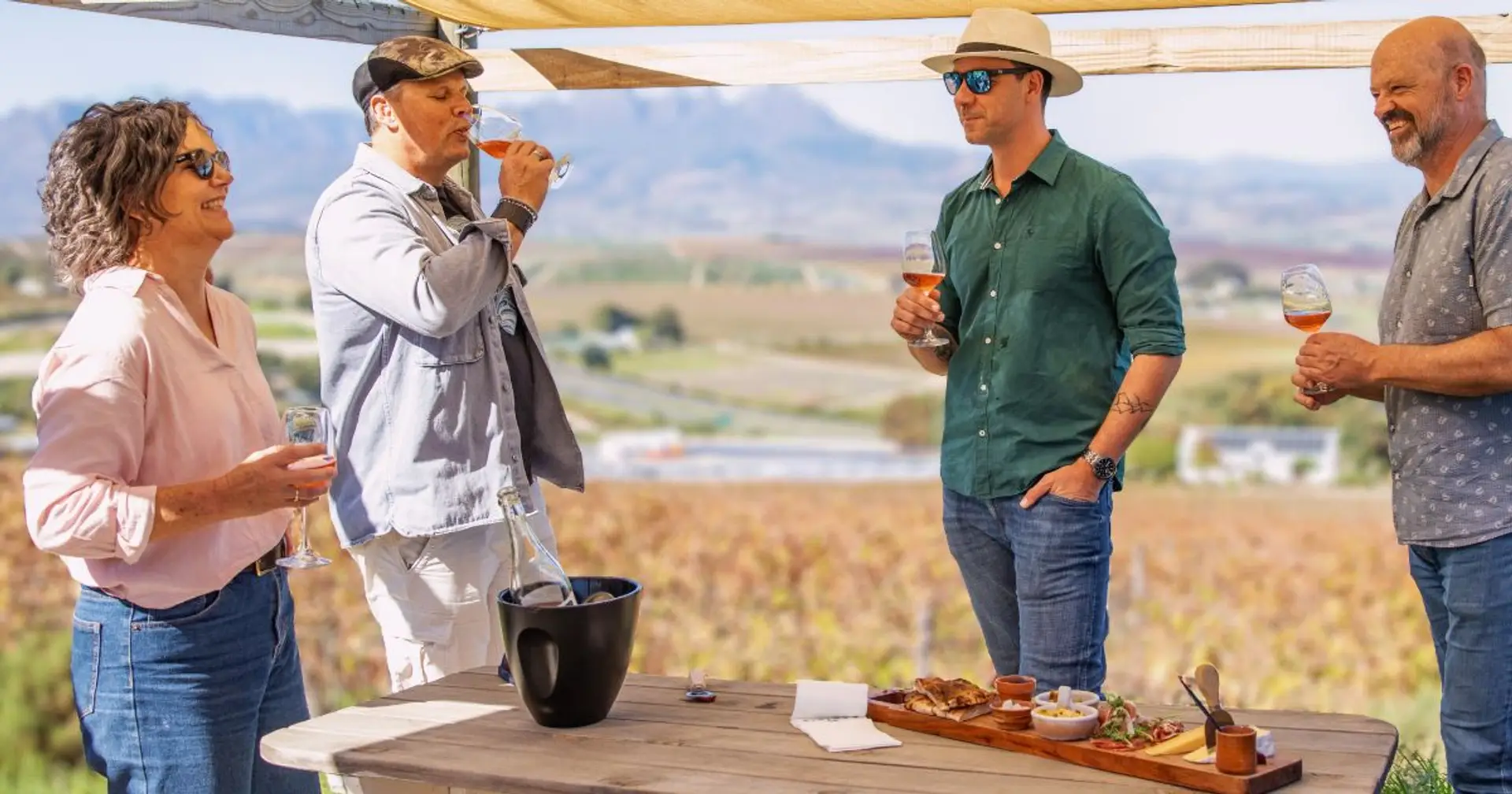 Guests tasting wine outdoors at a Stellenbosch estate